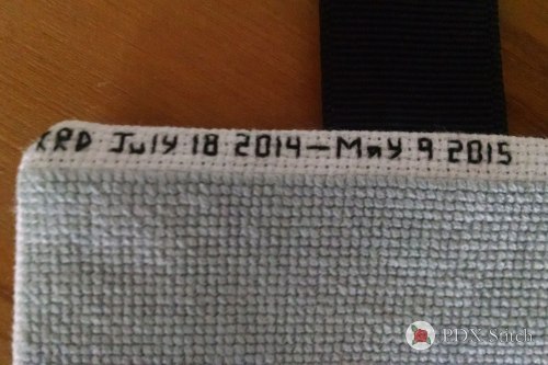 close-up photograph of back-stitched dates reading July 18 2014 to May 9 2015 